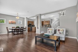 Hardwood-finish flooring throughout, recessed lighting, and a chandelier in the dining area - 