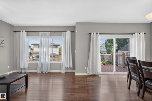 Hardwood flooring, sliding glass door, white trim, track lighting, and a private wood deck - 9515 221 Street Nw, Edmonton, AB - Indoor