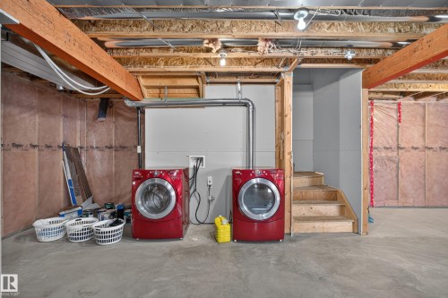 Unfinished basement with exposed ceiling joists, concrete flooring, and partial wall insulation - 9515 221 Street Nw, Edmonton, AB - Indoor Photo Showing Basement