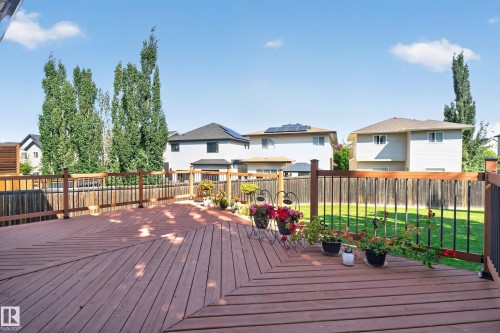 Spacious wooden deck with perimeter railing and a manicured lawn area - 9515 221 Street Nw, Edmonton, AB - Outdoor With Deck Patio Veranda With Exterior