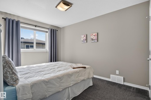 Neutral wall tones with dark carpeting - 9515 221 Street Nw, Edmonton, AB - Indoor Photo Showing Bedroom
