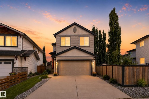 Two-story exterior with light-toned siding, attached two-car garage, and a concrete driveway - 9515 221 Street Nw, Edmonton, AB - Outdoor