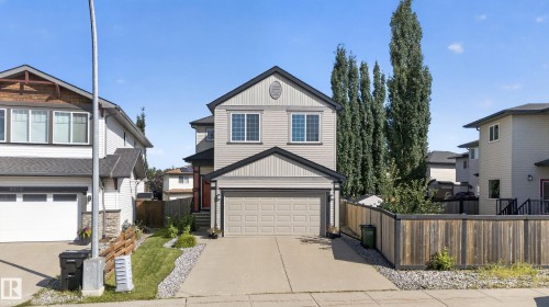 Two-story property with light siding, an attached garage, and a peaked roofline - 9515 221 Street Nw, Edmonton, AB - Outdoor