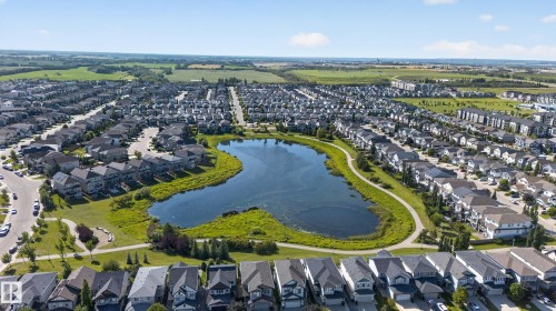 Suburban residential development with a central retention pond and surrounding green spaces - 9515 221 Street Nw, Edmonton, AB - Outdoor With View