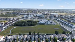 Expansive green spaces with paved pathways and surrounding residential developments - 
