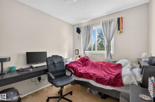 Window with natural light, wall-mounted desk, neutral wall color, textured ceiling - 18247 93 Avenue Nw, Edmonton, AB - Indoor