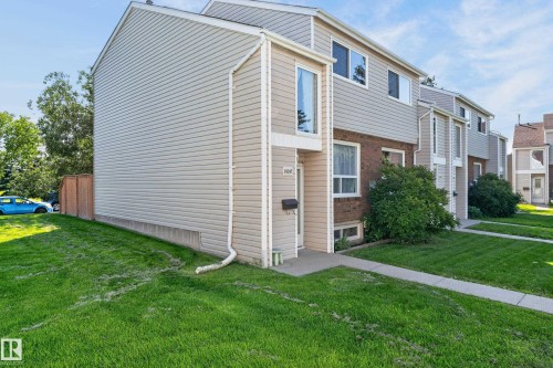 Two-story exterior with horizontal siding, brick accents, a gabled roofline, and a concrete pathway leading to the entry - 18247 93 Avenue Nw, Edmonton, AB - Outdoor