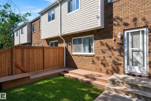Private fenced yard featuring a wooden deck with integrated bench seating, and concrete steps - 18247 93 Avenue Nw, Edmonton, AB - Outdoor With Exterior