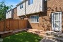 Private fenced yard featuring a wooden deck with integrated bench seating, and concrete steps - 18247 93 Avenue Nw, Edmonton, AB  - Outdoor With Exterior 