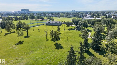 Expansive green space featuring mature trees, paved walking paths, and a tennis court - 18247 93 Avenue Nw, Edmonton, AB - Outdoor With View