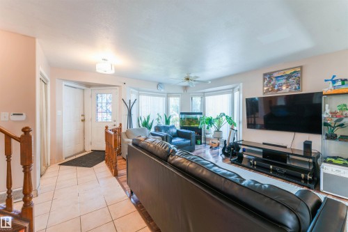 Tiled entry with wood-finish flooring extending into the living space - 4609 38A Avenue Nw, Edmonton, AB - Indoor Photo Showing Living Room