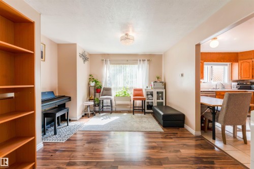 Wood-finish flooring throughout, with neutral wall tones and a ceiling-mounted light fixture - 4609 38A Avenue Nw, Edmonton, AB - Indoor