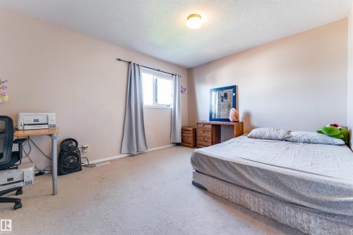 Recessed window with drapes, wall-mounted light fixture, and neutral wall color - 4609 38A Avenue Nw, Edmonton, AB - Indoor Photo Showing Bedroom