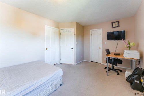 Light-colored walls, white trim, and carpeted flooring - 4609 38A Avenue Nw, Edmonton, AB - Indoor Photo Showing Bedroom