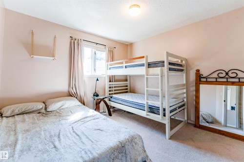 Wall-to-wall carpeting and a ceiling-mounted light fixture - 4609 38A Avenue Nw, Edmonton, AB - Indoor Photo Showing Bedroom