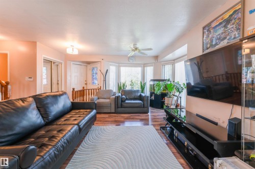 Bay window with vertical blinds, wood-finish flooring, ceiling fan, and recessed lighting - 4609 38A Avenue Nw, Edmonton, AB - Indoor Photo Showing Living Room