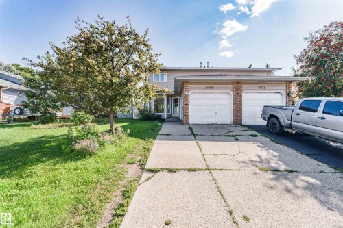 Two-story exterior with two attached garages, a concrete driveway, and a mature tree - 4609 38A Avenue Nw, Edmonton, AB - Outdoor