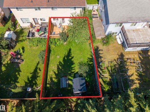 Expansive backyard featuring a wood deck, mature trees, and a storage shed - 4609 38A Avenue Nw, Edmonton, AB - Outdoor