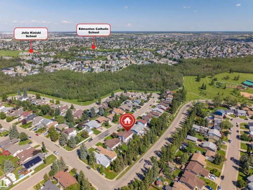 Aerial perspective of a residential neighborhood with established homes, tree-lined streets, and surrounding green spaces - 4609 38A Avenue Nw, Edmonton, AB -  With View