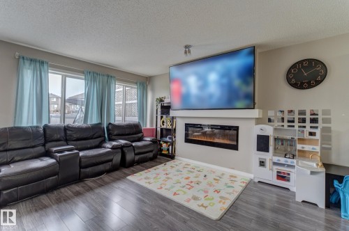 6706 24 Avenue Sw, Edmonton, AB - Indoor Photo Showing Living Room With Fireplace
