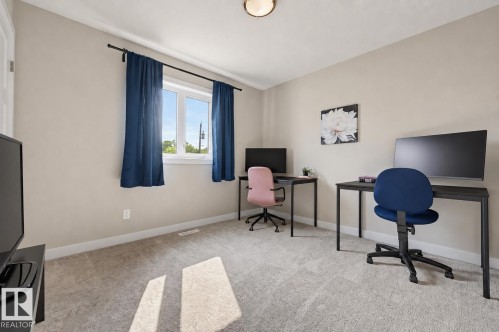 Neutral wall paint with white trim, a double window, and light-toned carpeting - 12219 93 Street Nw, Edmonton, AB - Indoor