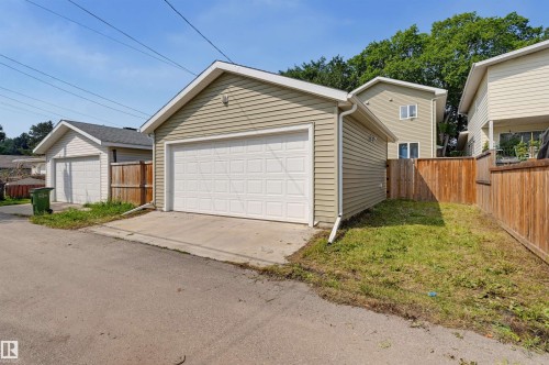 Detached garage with horizontal siding, a pitched roof, and a panel-style garage door - 12219 93 Street Nw, Edmonton, AB - Outdoor With Exterior