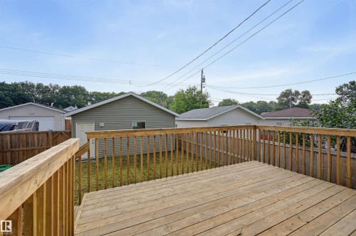 Spacious wood-finish deck with railing overlooking a fenced backyard - 12219 93 Street Nw, Edmonton, AB - Outdoor With Deck Patio Veranda With Exterior