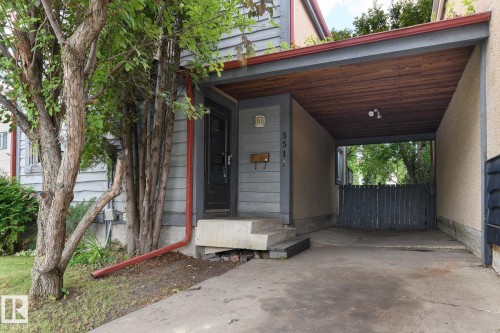 Covered carport with a wood-finish ceiling, exterior lighting, and concrete flooring - 5511 92C Avenue Nw, Edmonton, AB - Outdoor With Exterior
