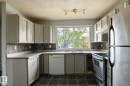 Kitchen featuring white cabinetry, a tiled backsplash, and stainless steel appliances - 5511 92C Avenue Nw, Edmonton, AB  - Outdoor 