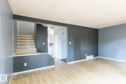 Light wood-finish flooring throughout the main living area - 5511 92C Avenue Nw, Edmonton, AB - Indoor Photo Showing Other Room