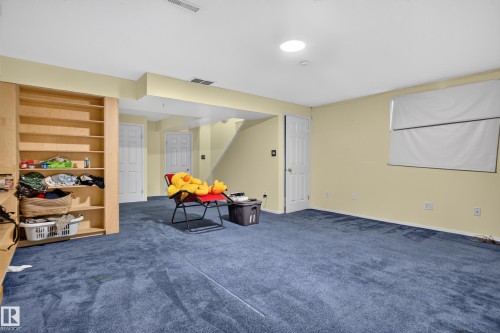 Built-in shelving, recessed lighting, and a white interior door - 3755 20 Street Nw, Edmonton, AB - Indoor Photo Showing Other Room