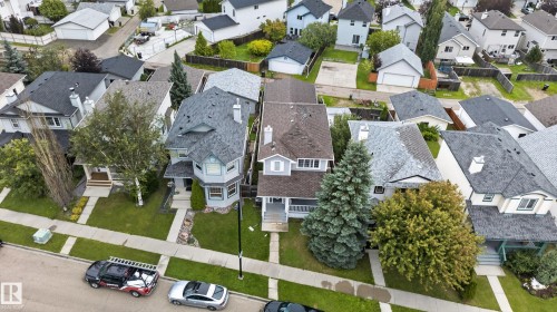 Gable rooflines with asphalt shingles, mature trees, and landscaping - 3755 20 Street Nw, Edmonton, AB - Outdoor