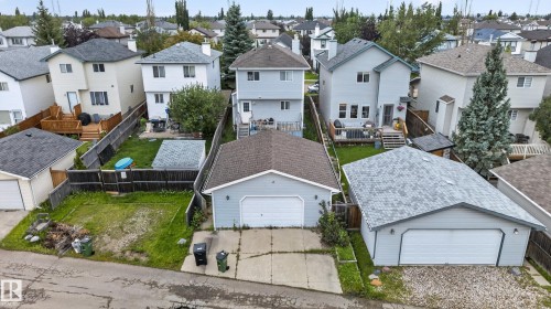 Two-story residence featuring a detached garage with a white overhead door and a second detached garage with a white overhead door - 3755 20 Street Nw, Edmonton, AB - Outdoor