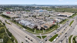 Expansive commercial district featuring multiple retail establishments and a large parking area - 