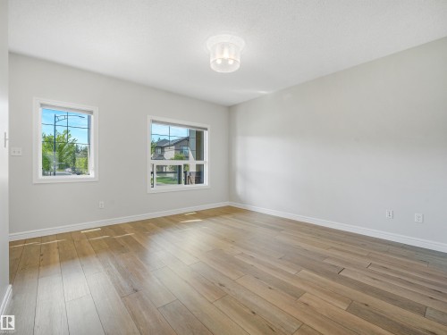 Hardwood-style flooring throughout - 203 Cavanagh Common Sw, Edmonton, AB - Indoor Photo Showing Other Room