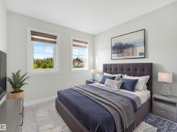 Two windows with integrated blinds, a tufted headboard, and light-colored carpeting - 