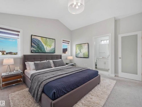Vaulted ceiling with a contemporary flush mount light fixture - 203 Cavanagh Common Sw, Edmonton, AB - Indoor Photo Showing Bedroom
