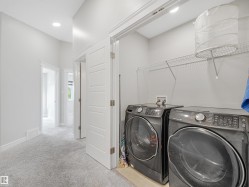 Dedicated laundry space with wire shelving and recessed lighting - 