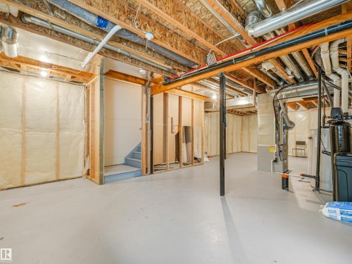 Unfinished basement offering exposed wood framing, insulated walls, concrete flooring, and visible utility systems - 203 Cavanagh Common Sw, Edmonton, AB - Indoor Photo Showing Basement