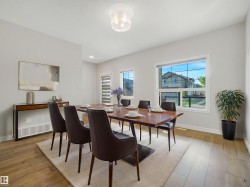 Recessed lighting, wood-finish flooring, white window frames, and a glass-enclosed light fixture - 