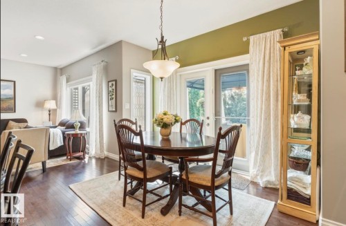 Dining area with wood-finish flooring and direct access to the outdoor space - 22 Voleta Crest, Spruce Grove, AB - Indoor Photo Showing Dining Room