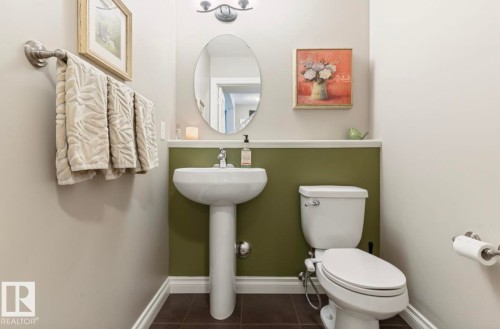 Pedestal sink with chrome faucet, oval mirror, and two-tone wall treatment - 22 Voleta Crest, Spruce Grove, AB - Indoor Photo Showing Bathroom