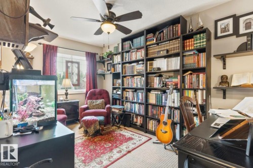 Room with extensive built-in shelving, a ceiling fan, and carpeted flooring - 22 Voleta Crest, Spruce Grove, AB - Indoor Photo Showing Office