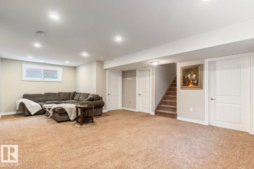 Carpeted lower level featuring recessed lighting, a window with frosted glass, and two paneled doors - 22 Voleta Crest, Spruce Grove, AB - Indoor Photo Showing Basement