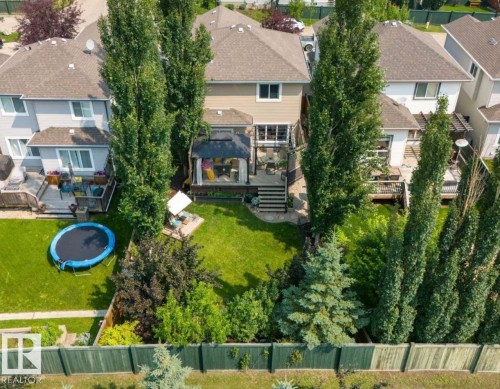 Expansive backyard featuring a multi-level deck, mature trees, a manicured lawn, a covered gazebo, and a privacy fence - 22 Voleta Crest, Spruce Grove, AB - Outdoor With Deck Patio Veranda