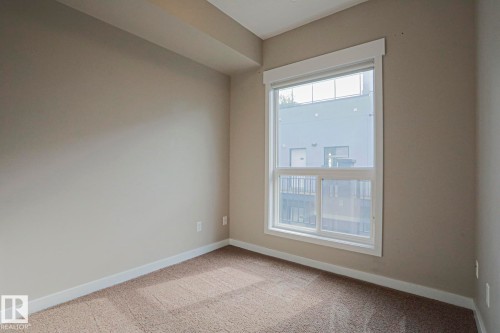 Neutral tone walls and carpeting create a versatile interior - #607 10518 113 St Nw Nw, Edmonton, AB - Indoor Photo Showing Other Room