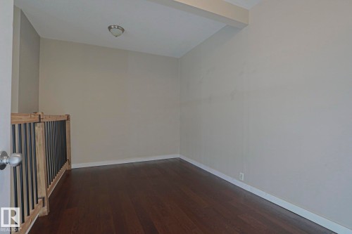 Wood-finish flooring, ceiling-mounted light fixture, and light-toned walls - #607 10518 113 St Nw Nw, Edmonton, AB - Indoor Photo Showing Other Room