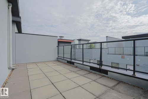 Concrete paver patio with a glass and metal railing - #607 10518 113 St Nw Nw, Edmonton, AB - Outdoor