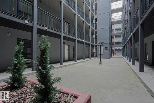 Multi-level building with individual unit entrances and black metal railings - #607 10518 113 St Nw Nw, Edmonton, AB - Outdoor With Balcony