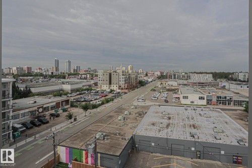 Urban landscape featuring a mix of commercial and residential buildings, with a prominent city skyline in the distance - #607 10518 113 St Nw Nw, Edmonton, AB - Outdoor With View